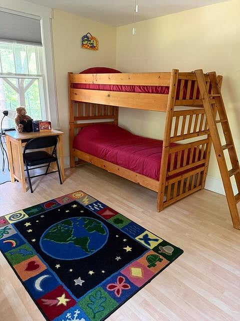 The private bedroom boasts comfortable twin mattress bunk beds, a workspace, and a door which closes for quiet and privacy between the two sleeping areas.