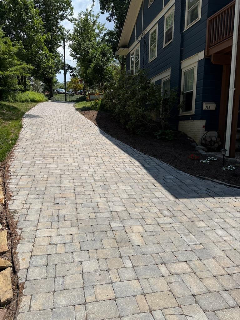 The recently pavered drive leads down the hill to your private parking spot.