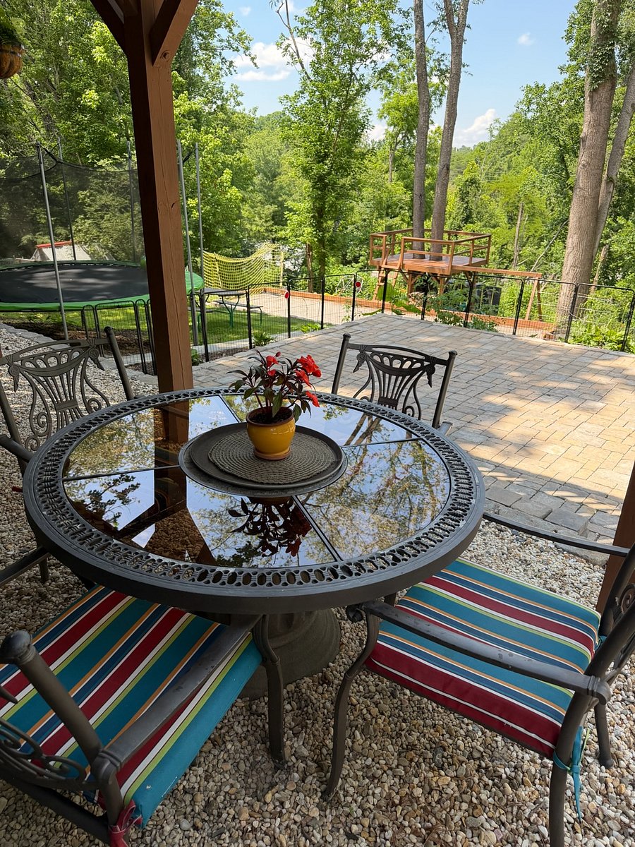 Enjoy al fresco dining steps from the unit and kitchen looking out to the wooded landscape and yard.