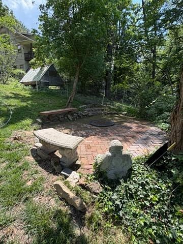The backyard boasts a variety of activities for all ages including a multi-purpose court with gear for bocce, badminton, and soccer practice, a fire pit, tree fort with swings, slide, climbing wall, and geodesic climbing structure.