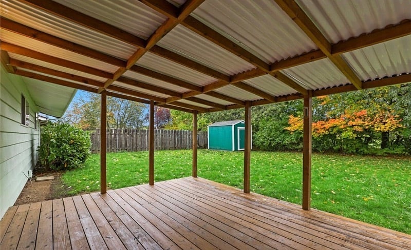 Outdoor deck. Has table and chairs.