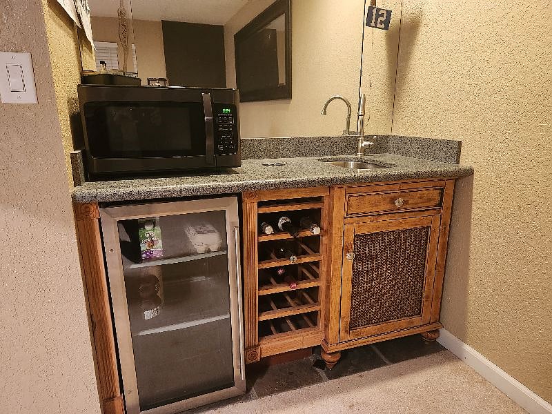 Kitchenette with frig, sink and microwave (coffee maker available), within feet of room on lower level.