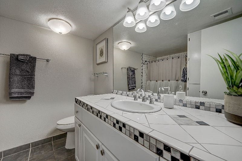 Bathroom has a shower and tub and lots of cabinet space