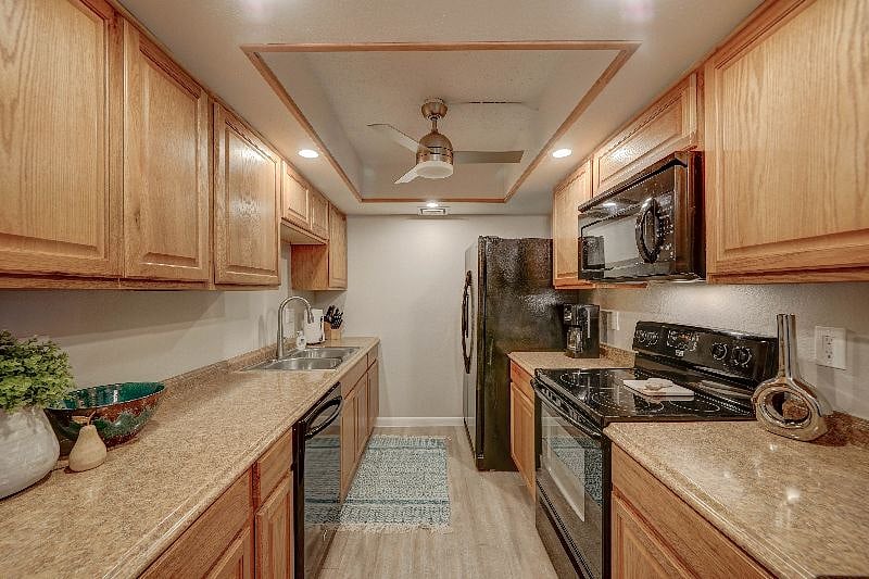 Galley style kitchen is fully stocked and has a dishwasher, stove and microwave