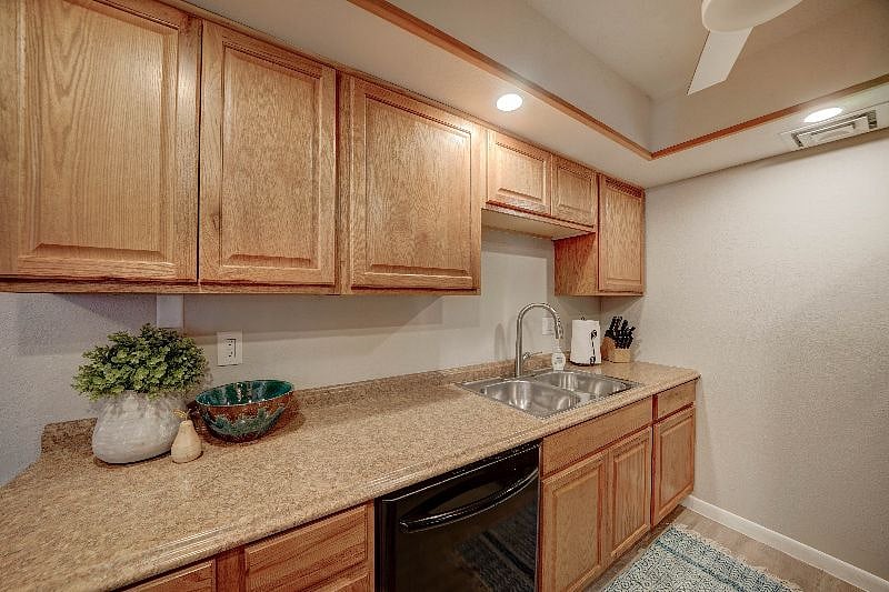 Galley style kitchen is fully stocked and has a dishwasher, stove and microwave