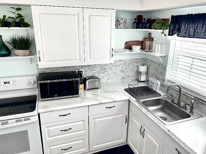 Kitchen with new cabinets, counters and back splash. 