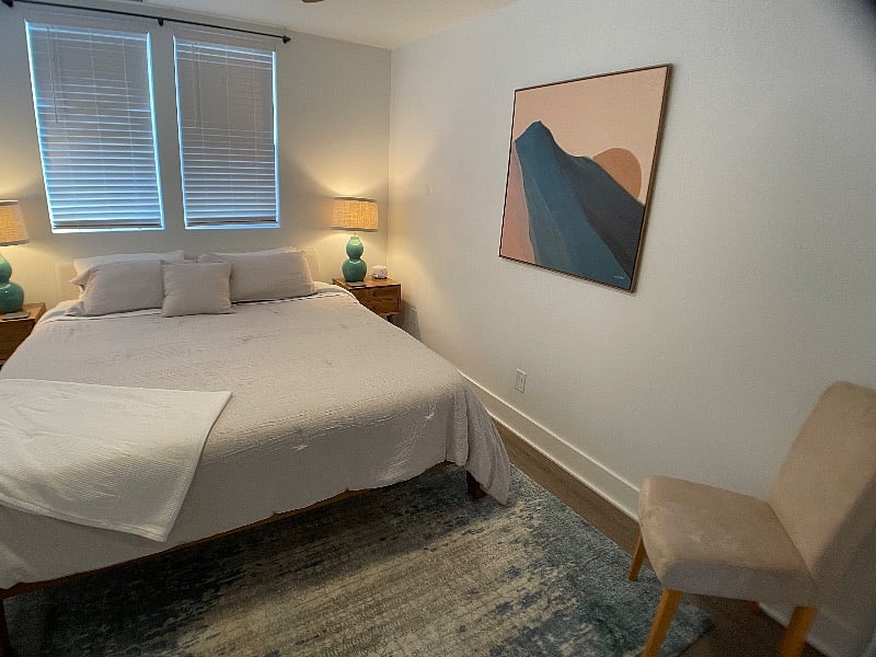 Master bedroom.
California King, organic Birch mattress w pillow topper, sound machine, essential oil diffuser, alarm clock.