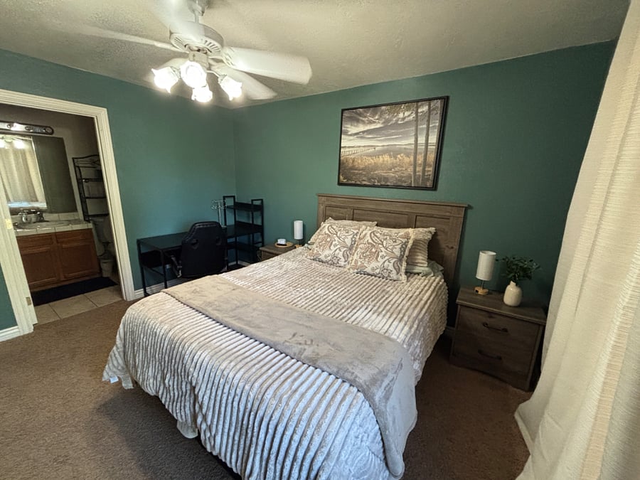Primary bedroom with queen bed, ensuite bathroom, smart TV and plenty of dressers/closet space for your things.  Desk to work from home too!