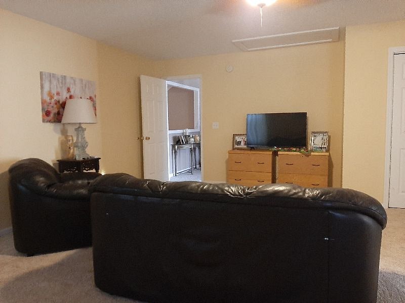 Private TV room upstairs with a desk for working at home.
