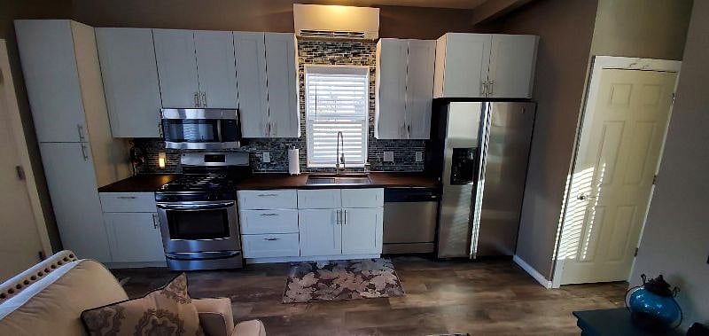 Full kitchen, Stainless Appliances with Gas Range, Butcher Block Counters, Glass Tile Backsplash. New Mitsubishi Mini-Split AC & Heat