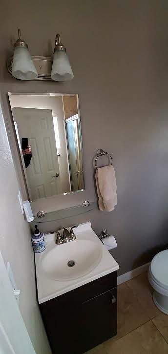 Bathroom has small window with privacy glass, a medicine Cabinet and travertine flooring.