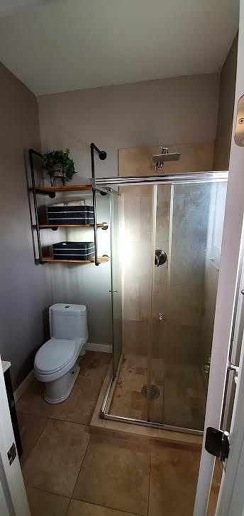 Bathroom has Rain Shower head and two new full sets of towels.  Extra storage for TP and extras