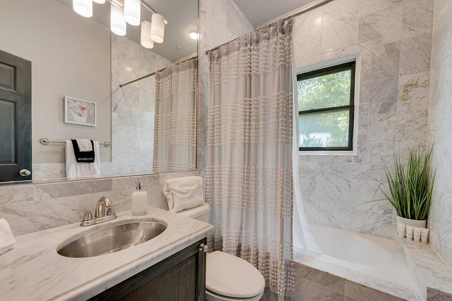 Primary bathroom with a shower and bathtub combo, offering the perfect space to unwind and soak for extra relaxation.
