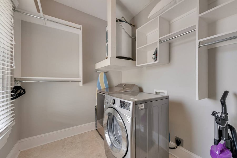 Spacious, separate laundry room with ample storage and a large closet for added convenience.