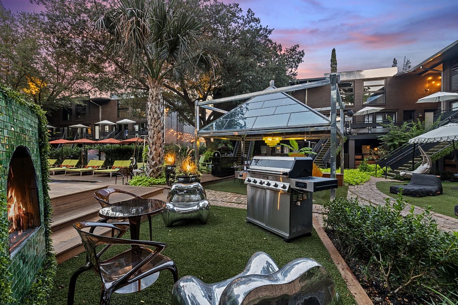 Enjoy your second wellness Resort style courtyard @ 6011 Gaston Ave with striped umbrellas and garden paths. Wellness products available for our residents.
