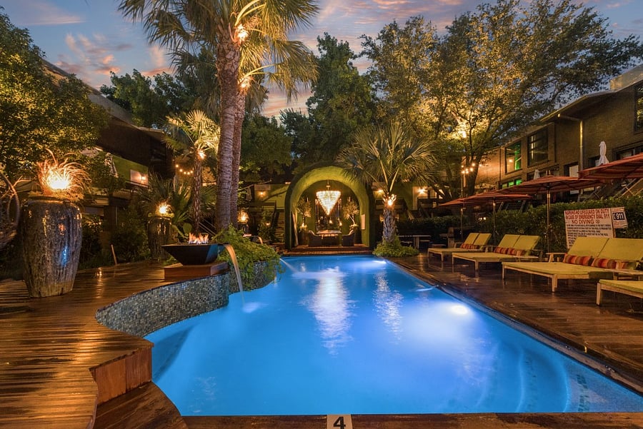 Enjoy your second wellness Resort style courtyard @ 6011 Gaston Ave with striped umbrellas and garden paths. Wellness products available for our residents.