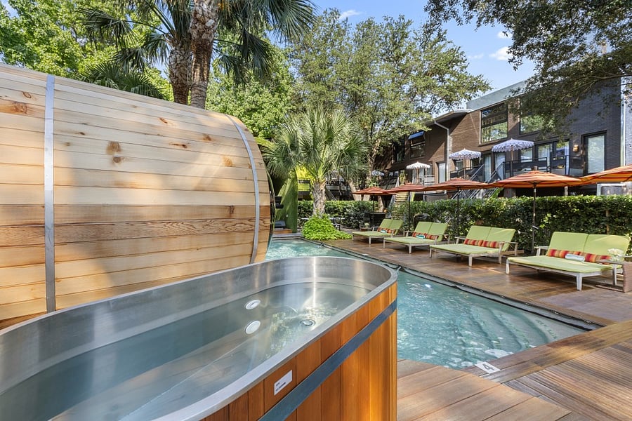 Enjoy your second wellness Resort style courtyard @ 6011 Gaston Ave with striped umbrellas and garden paths. Wellness products available for our residents.