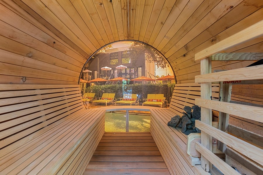 Enjoy your second wellness Resort style courtyard @ 6011 Gaston Ave with striped umbrellas and garden paths. Wellness products available for our residents.