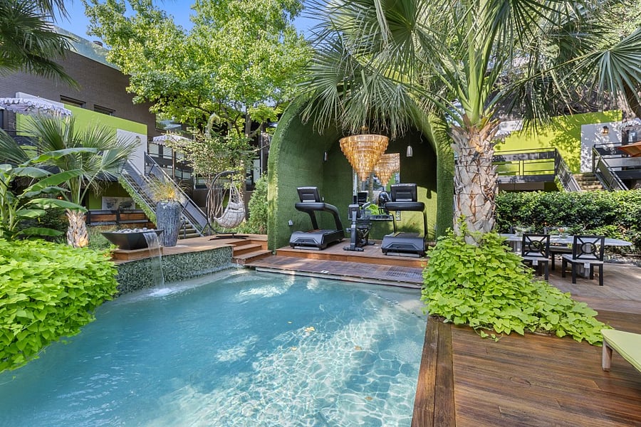 Enjoy your second wellness Resort style courtyard @ 6011 Gaston Ave with striped umbrellas and garden paths. Wellness products available for our residents.