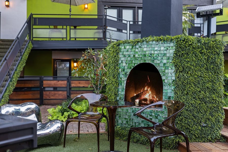 Enjoy your second wellness Resort style courtyard @ 6011 Gaston Ave with striped umbrellas and garden paths. Wellness products available for our residents.