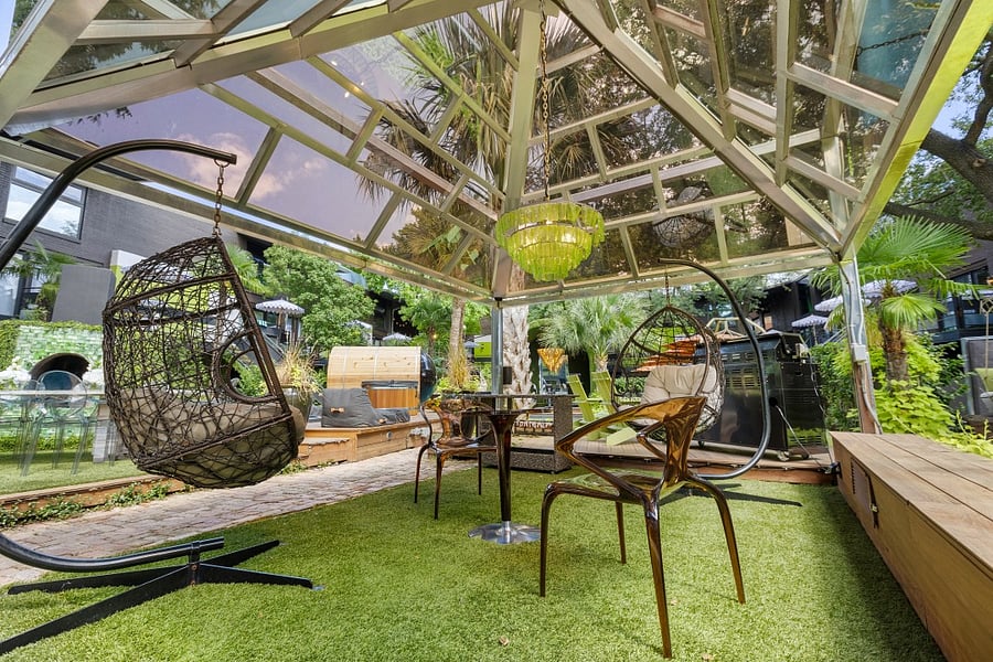 Enjoy your second wellness Resort style courtyard @ 6011 Gaston Ave with striped umbrellas and garden paths. Wellness products available for our residents.