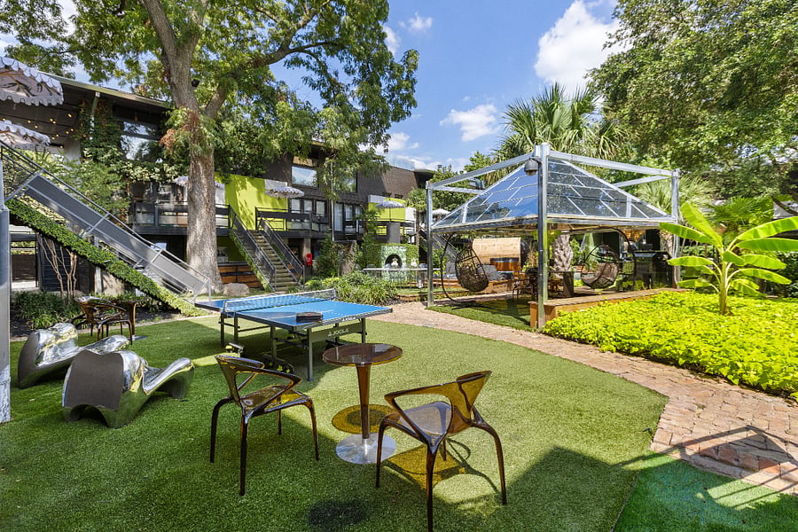 Enjoy your second wellness Resort style courtyard @ 6011 Gaston Ave with striped umbrellas and garden paths. Wellness products available for our residents.