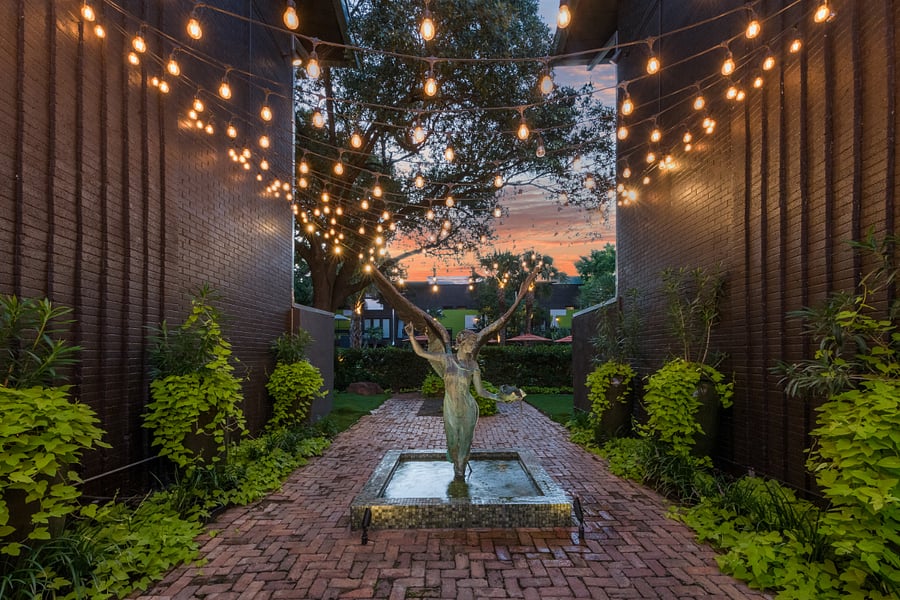 Enjoy your second wellness Resort style courtyard @ 6011 Gaston Ave with striped umbrellas and garden paths. Wellness products available for our residents.