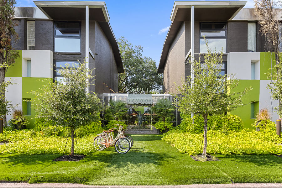 Enjoy your second wellness Resort style courtyard @ 6011 Gaston Ave with striped umbrellas and garden paths. Wellness products available for our residents.