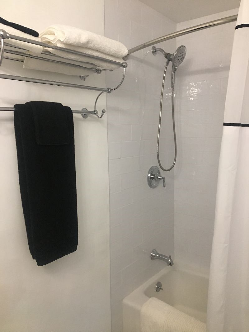 Full bath with tub and hand held shower
