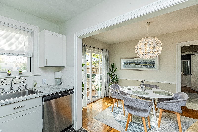 The sunny kitchen and dining room connect to the outdoor deck for easy entertaining.