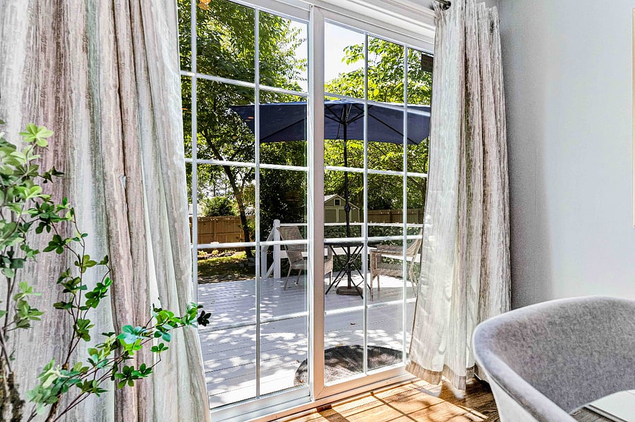 Step outside from the dining room to the large deck overlooking the backyard.