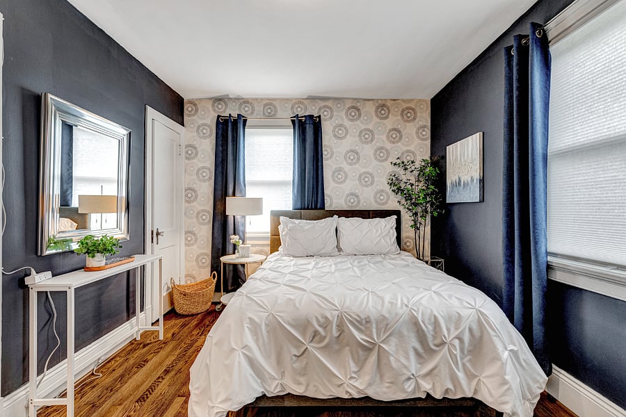 Beautiful art, a closet for clothing storage and comfortable bed.