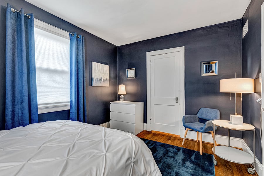 Bedroom mirrors, drawers for clothing and a charming seating area.