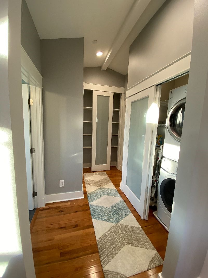 Wide hallway with 8 tall linen closet.