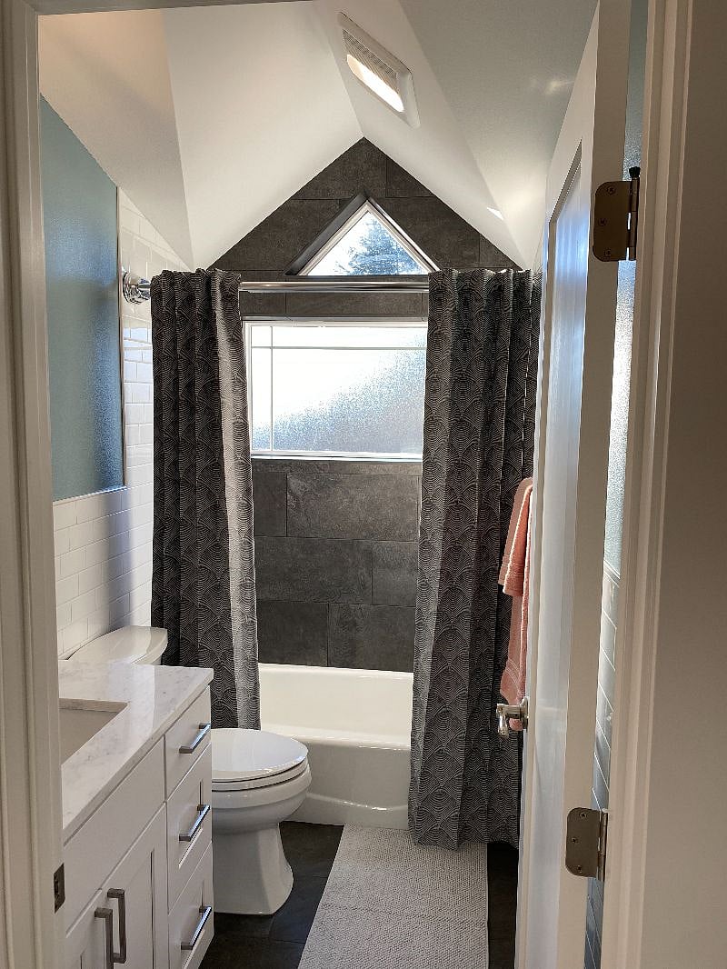 Dormer perfectly frames vaulted bathroom ceiling