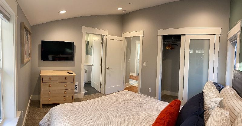 2nd bedroom includes an en-suite bathroom, queen size bed, and dresser.