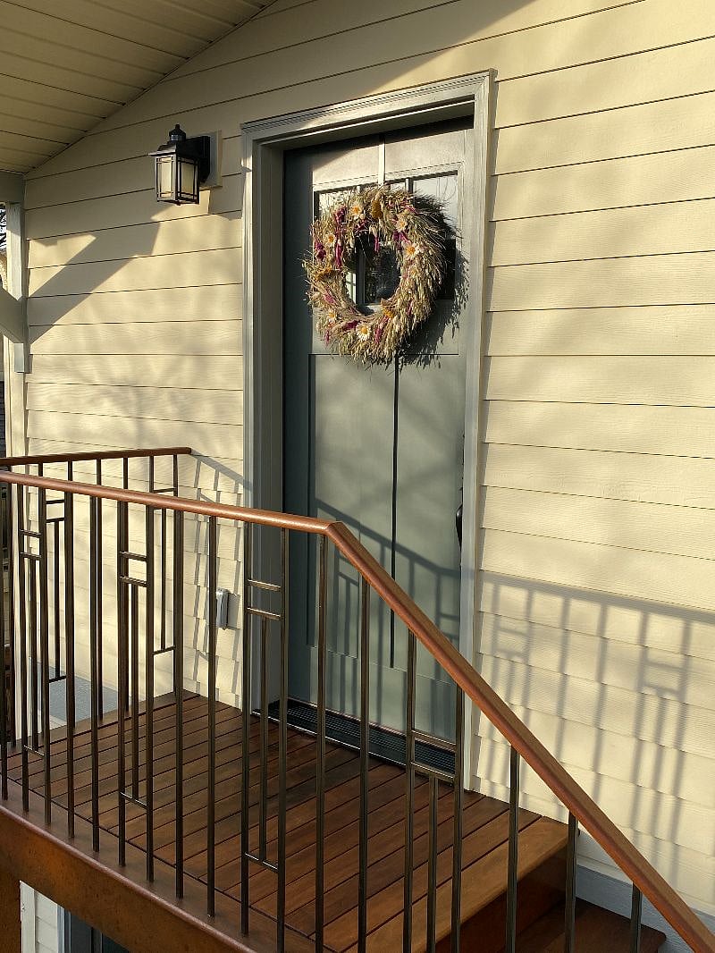 Entryway includes a hand-built railing with a Brazilian ipe handrail.