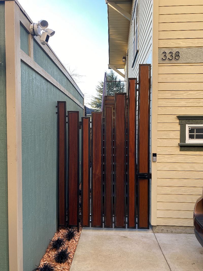 Gate has an electronic key code knob for easy access and a ring doorbell.