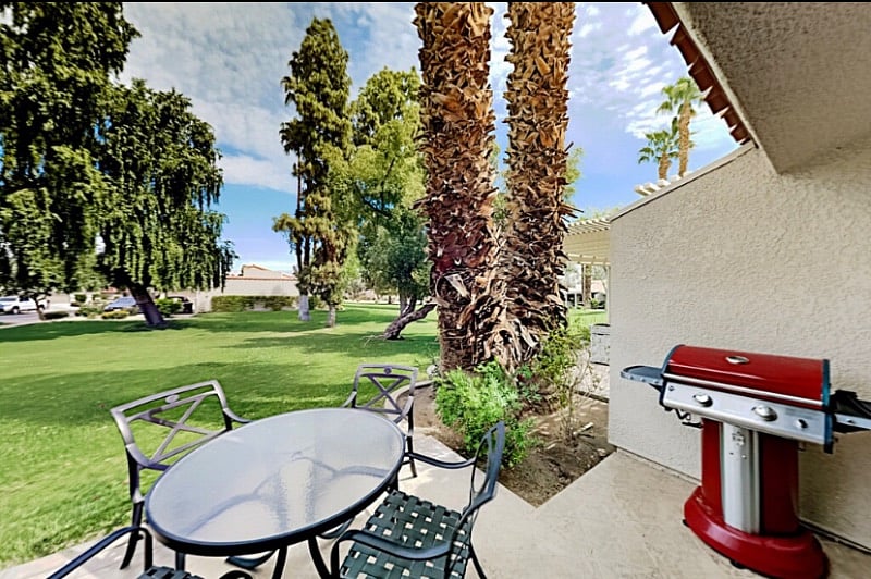 View from patio, complete with patio table and gas grill.