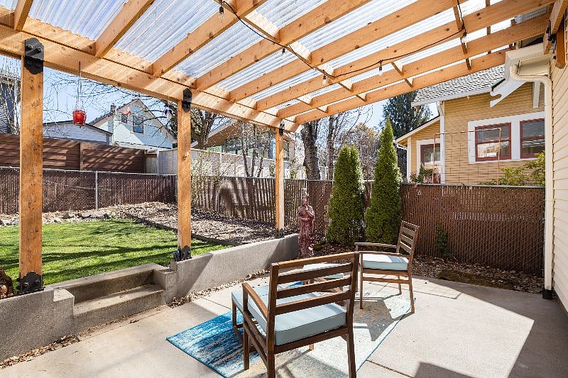 covered patio and lawn area looking from driveway.