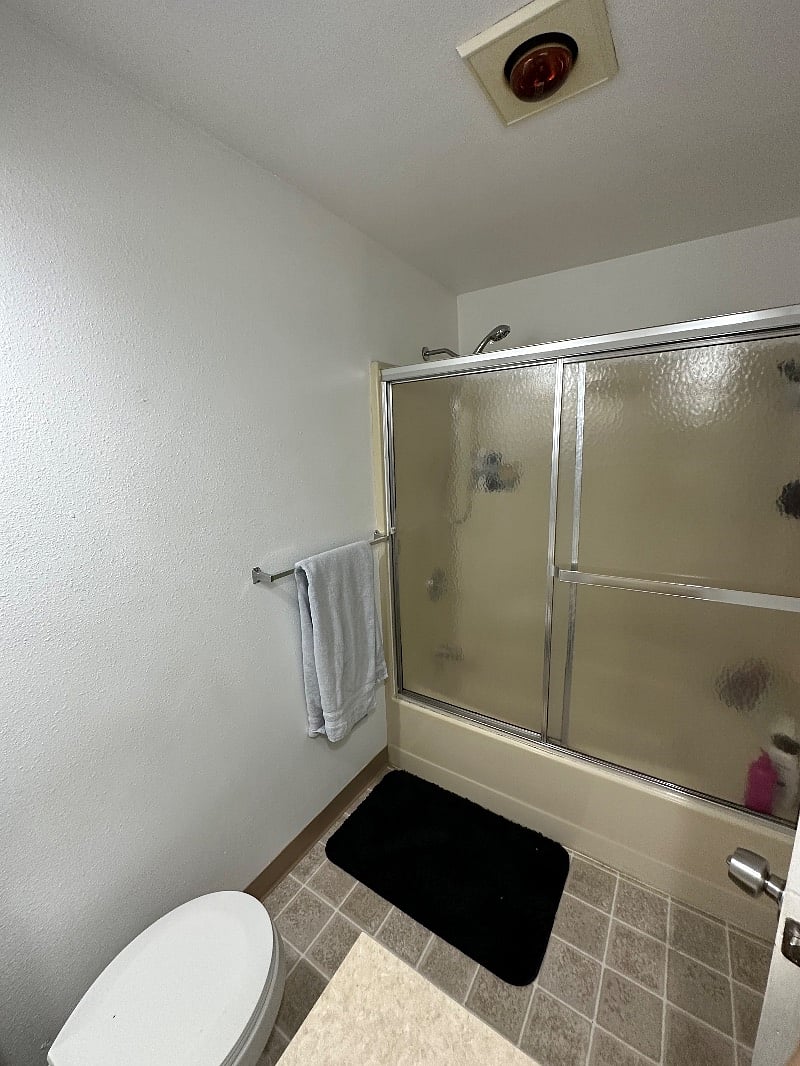 Private full bathroom with shower over tub combo.