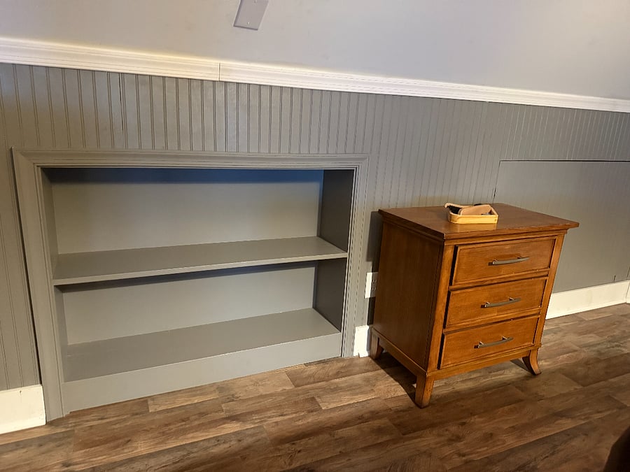 Built in shelving for additional storage in attic loft.