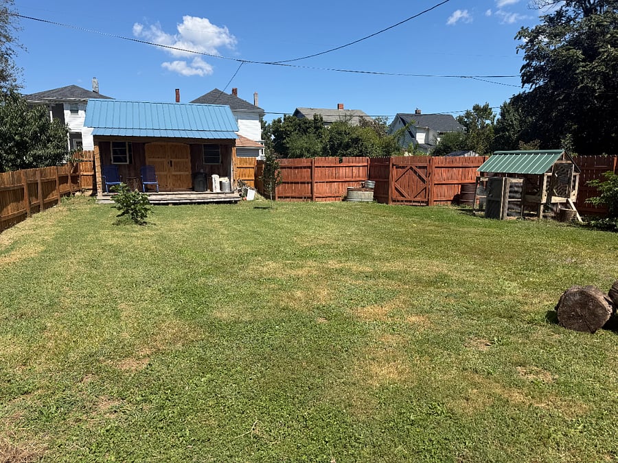 Fenced backyard, gate to alley parking, backyard chicken coop, shed for private use with shared use porch.