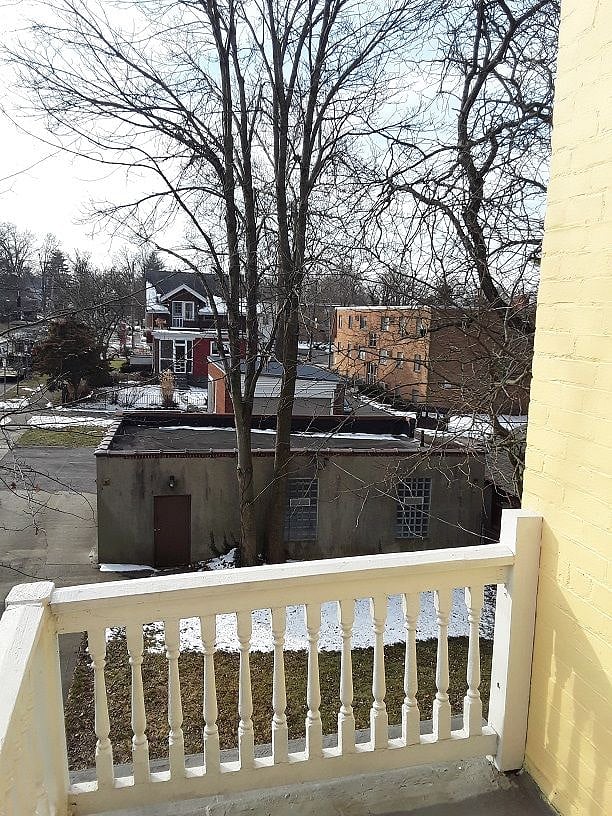 View of back yard and garage from kitchen balcony.