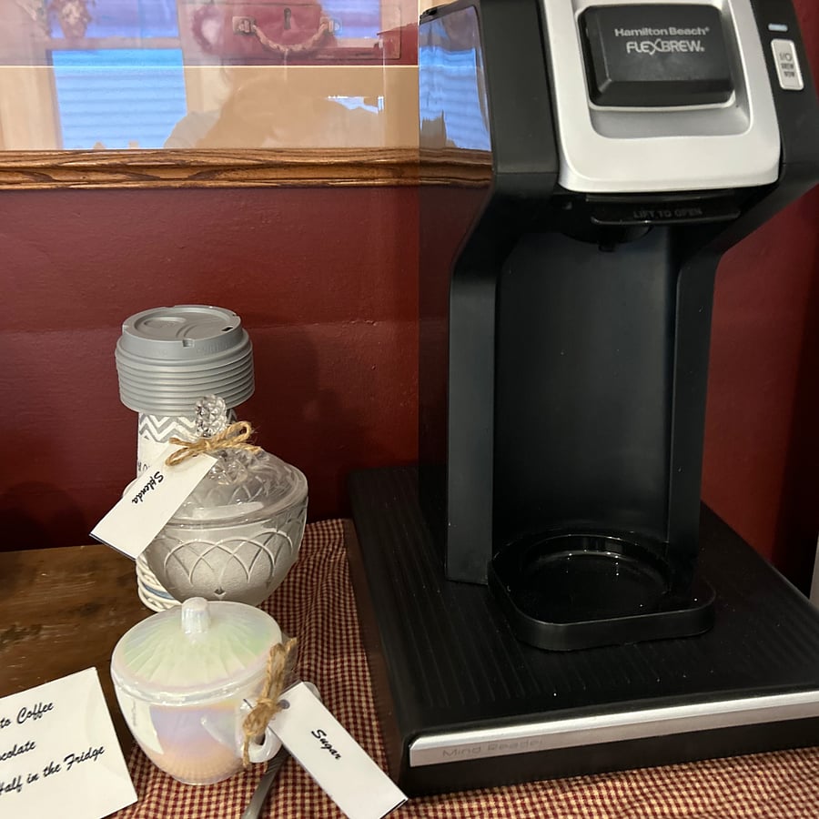 Keurig with coffee and hot chocolate and disposable cups for your use.