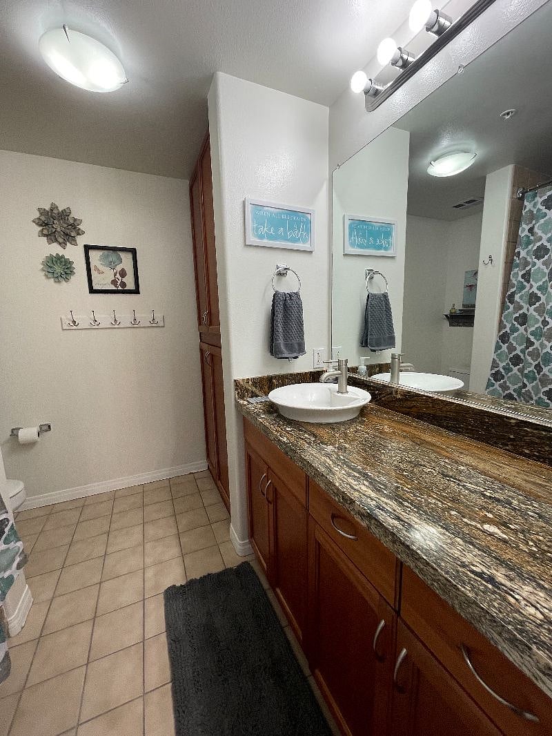 Main bathroom with shower and extra large bathtub with lots of cabinet storage