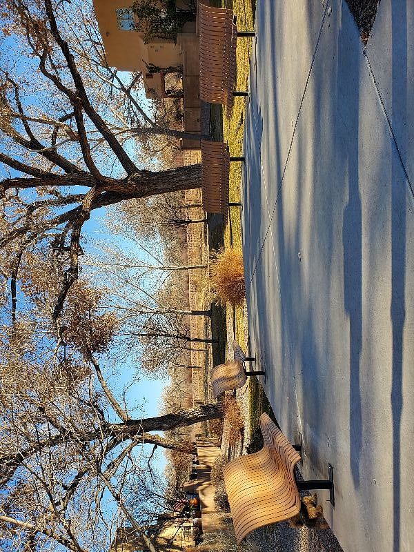 The private, gated community features a small park with direct access to the Bosque Trails.