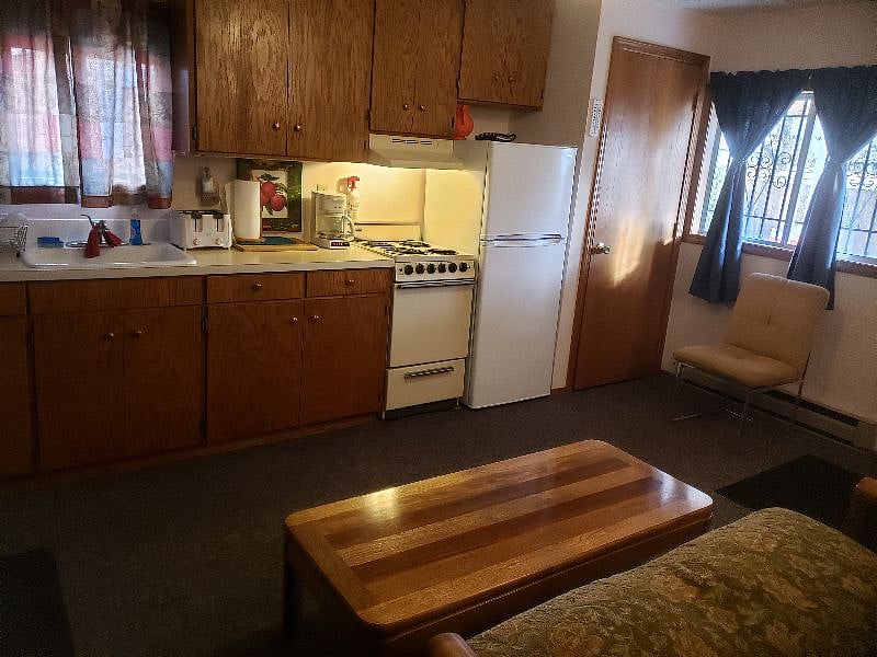 Everything for cooking is supplied, stove and oven work and fridge is new. Looking toward front door.