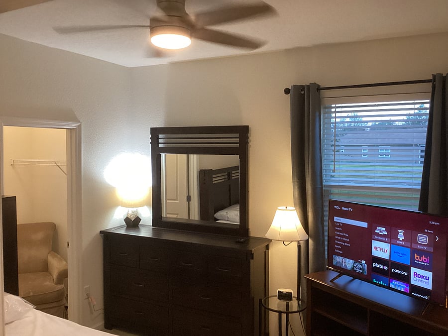 BED ROOM - View of dresser & mirror, TV and window.