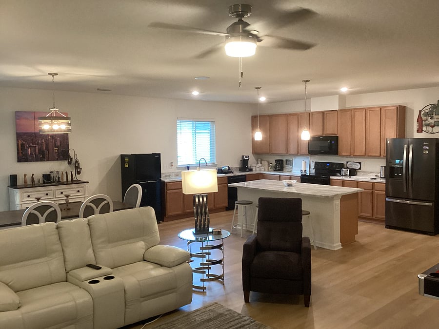 LOUNGE & KITCHEN AREA - View of sofa, Kitchen breakfast island, kitchen cabinets, appliances and window.